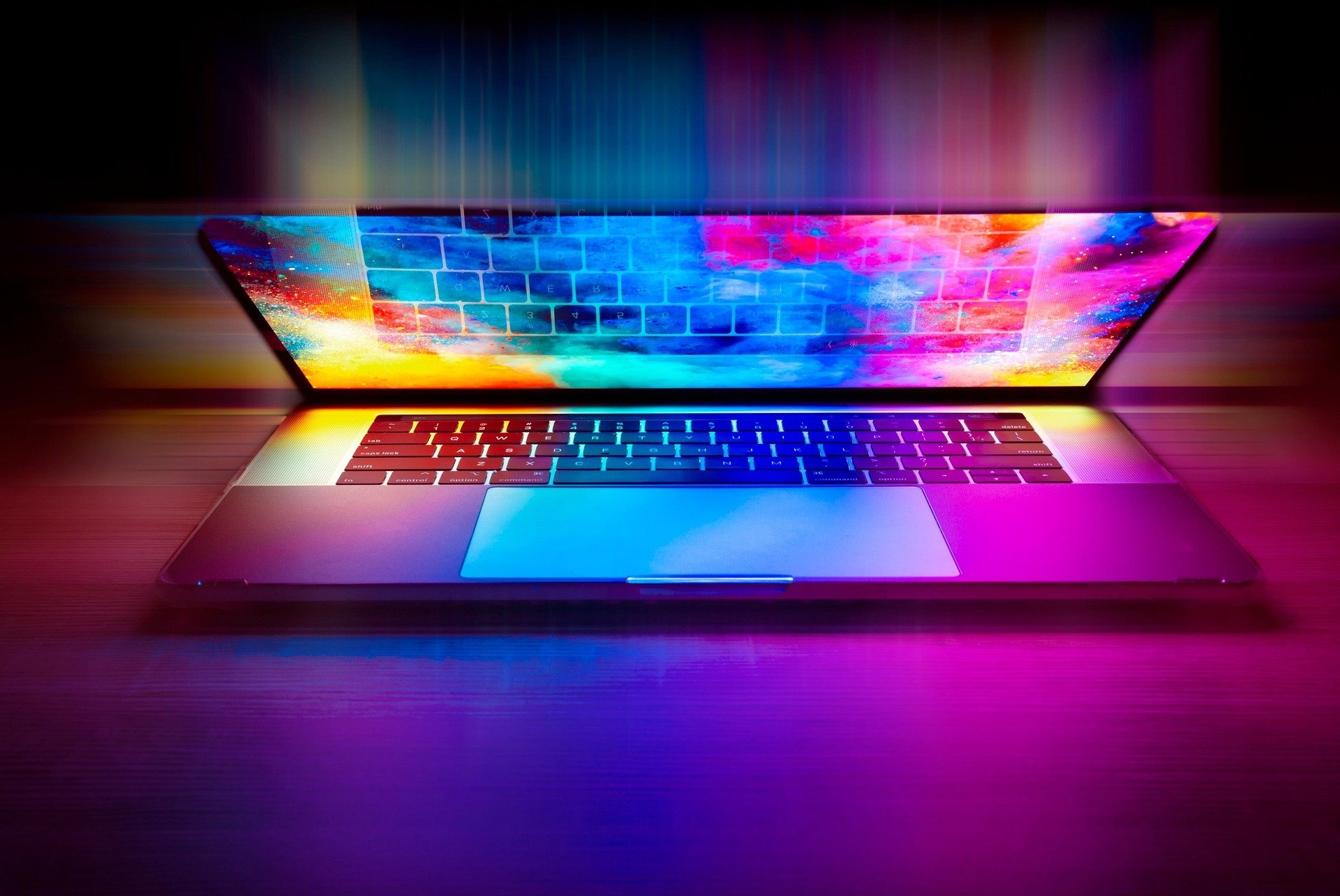 laptop slightly open with multicolor background on