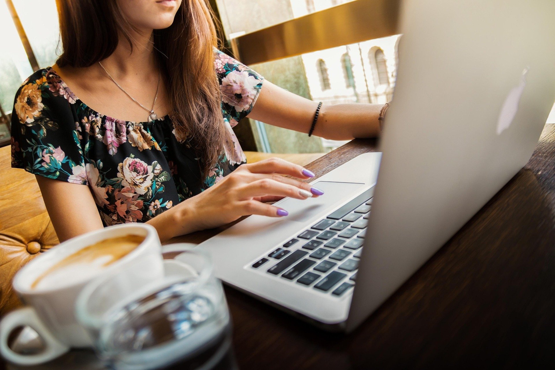 woman working on computer in coffee shop